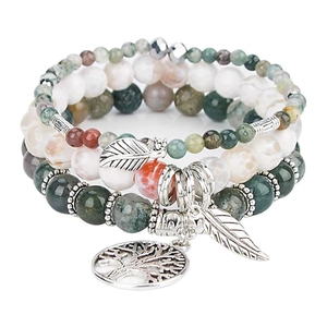 Detail of Tree of Life and feather charms on bohemian multi-layered beaded bracelets