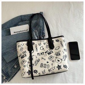 Detail of high-capacity graffiti tote bag with street style prints on white background
