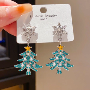 Detailed close-up of a sparkling Christmas tree earring with S925 silver needle