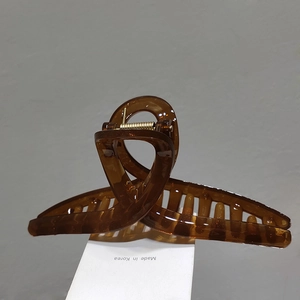 Detail of dark brown amber textured large hair claw clip with Made in Korea marking