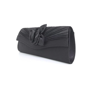 Detail of elegant black satin evening clutch featuring handmade floral texture and pleats