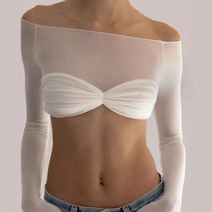 Detail of off-shoulder long sleeve sheer mesh top with inner tube top and denim jeans
