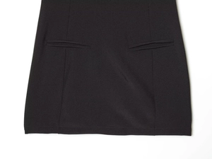 Detail view of high-quality pleated dress fabric with symmetrical welt pockets
