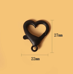 Macro detail of 27mm x 22mm black heart-shaped metal lobster clasp with size labels
