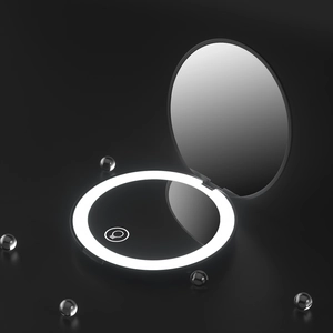 Macro view of folding LED makeup mirror with circular ring light and touch sensor switch