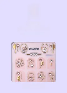 Detail of MJ-031 nail art kit featuring gold metal shapes and sparkling K9 rhinestones