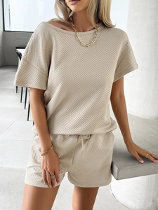 Detailed close-up of beige geometric knitted texture on casual summer two-piece outfit