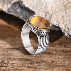 Close-up of vintage men's stainless steel ring with a large oval tiger eye stone inlay