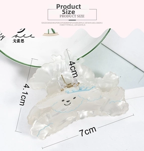 Macro view of a 7cm white resin hair claw clip with a blue cartoon dog illustration