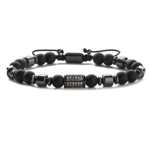 Herren Armband aus schwarzen mattierten Perlen mit Zirkonia-Zylinder und Flechtkordel
