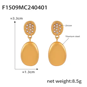 Detailed view of double-layered titanium gold earrings with zircon inlay and oval drop