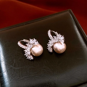 Macro detail of 18k gold plated earrings with zircon floral cluster and champagne pearls