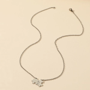 Polished stainless steel puzzle piece necklace with two matching pendants on O-chains