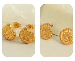 Detailed view of 18K gold plated shell earrings with spiral texture on jewelry stand