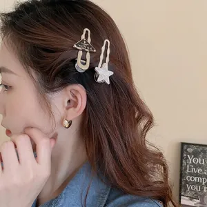 Y2K style heart and star hair clip set with rhinestones worn by a model in soft light