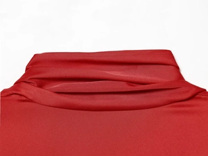 Detailed close-up of a red solid shirt showing the draped cowl neckline and fabric texture