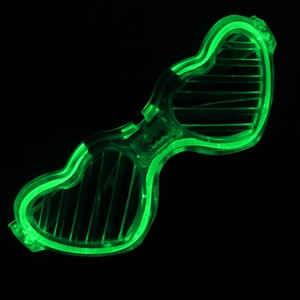 Detailed view of glowing green heart-shaped LED shutter glasses for party decoration