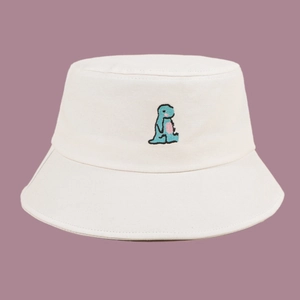 Detailed close-up of colorful dinosaur embroidery on a white cotton sun hat for summer
