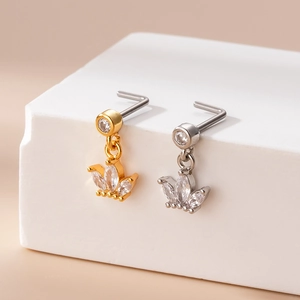 Macro detail of crown nose studs with micro-set zircons in gold and silver finishes