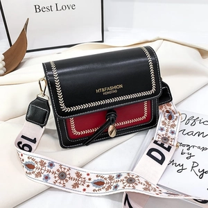 Chic black and red crossbody flap bag with embroidered lines and wide patterned strap