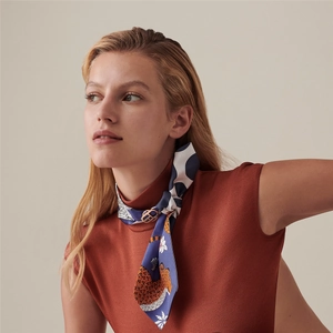 Detail of blue leopard print silk scarf with a golden figure-eight metal slide buckle