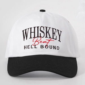 Close-up of high-quality WHISKEY letter embroidery on a white cotton baseball cap crown