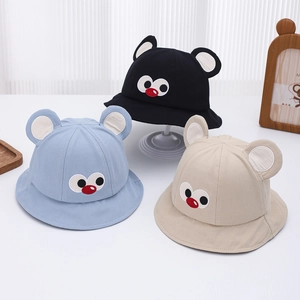 Detail of baby sun hats featuring cute bear ears and cartoon eye embroidery in soft cotton