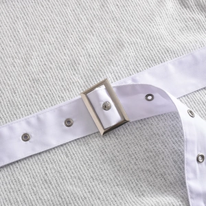Detailed close-up of white waffle texture fabric with matching belt and silver metal buckle