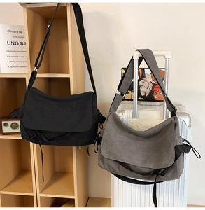 Detail of durable canvas messenger bags in black and gray with adjustable wide shoulder straps