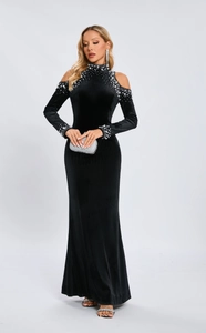 Detail of silver pearl and bead embellishments on black velvet long sleeve dress