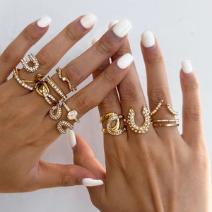Close-up of gold titanium steel rings with zircon stones worn on model's hands