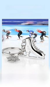 Detail of polished metal ice skate keychain with snowflake charm and engraved custom logo