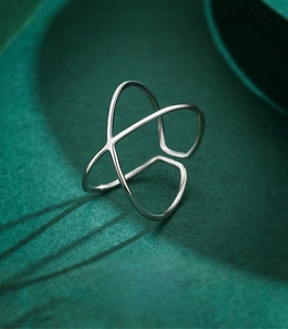 Detail of S925 sterling silver ring with polished crisscross geometric X design