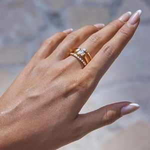 Detail showing stacked gold rings with rectangular and round white zircon stones