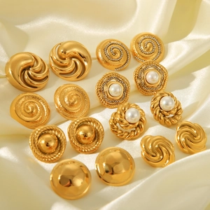 Collection of vintage 18K gold plated stainless steel pearl and spiral earrings on silk