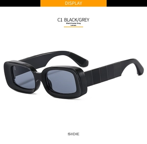 Side view of retro rectangular sunglasses with thick black frames and grey lenses