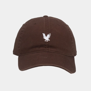 Close-up of eagle embroidery on a brown cotton baseball cap with twill fabric texture