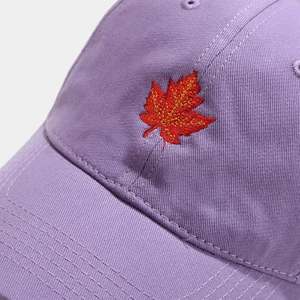 Purple cotton baseball cap featuring detailed red maple leaf embroidery on the front