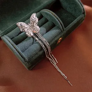 Elegant zircon butterfly tassel ear clip with long silver fringe on green velvet jewelry box