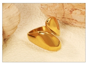 Detail of organic irregular gold ring with liquid metal texture on white texture