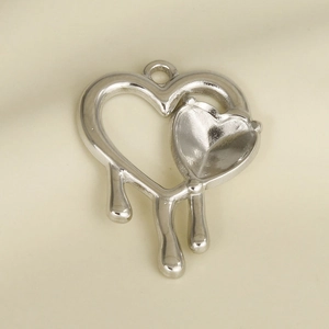 Macro shot of silver 304 stainless steel double heart pendant with melting drop effect