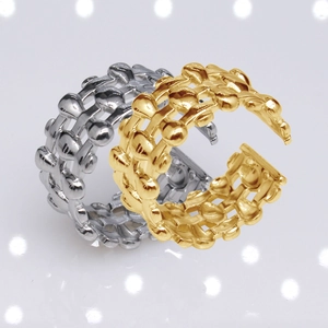 Macro shot of gold and silver chain style open rings in polished stainless steel