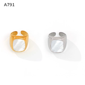 Detail of adjustable gold and silver rings with rectangular white mother of pearl inlay