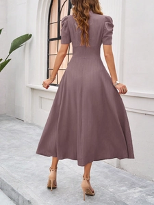 Rear view of a mauve short sleeve midi dress with elegant ribbed texture on the fabric