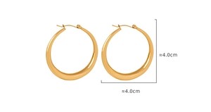 Detail view of large 40mm chunky gold hoop earrings with polished teardrop thick design