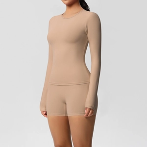 Detail view of skin-toned double-sided brushed long sleeve yoga top and shorts set