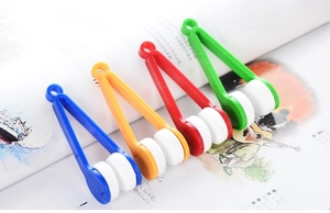 Portable eyeglass cleaning clips in blue, yellow, red, and green with soft cleaning pads