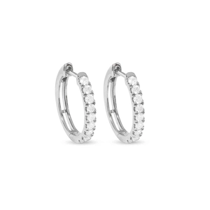 Detailed view of silver hoop earrings featuring pavé-set round cubic zirconia stones