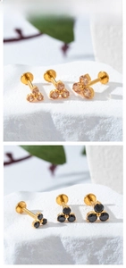 Detailed macro view of F136 titanium floral labret studs with three cubic zirconias