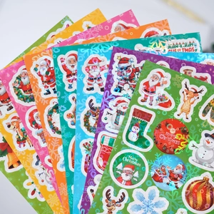 Detailed macro of laser laser Christmas stickers with Santa and reindeer festive designs